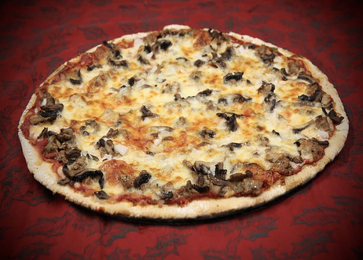 Marco's EBA deluxe thin crust pizza baked with cheese, sausage, pepperoni, mushrooms, onions, green peppers, and black olives